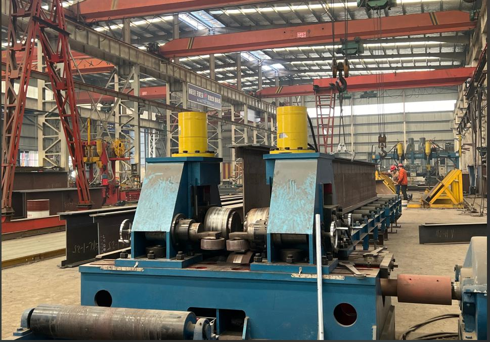 Rolling and forming machinery shaping structural steel members in the workshop