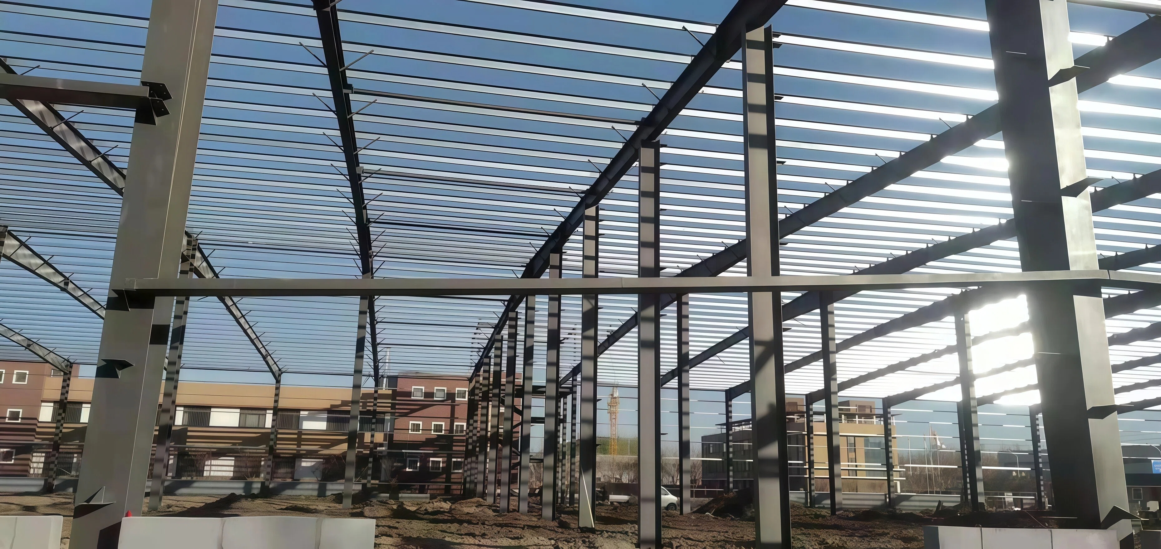 Steel structural frame of an industrial building against the sky